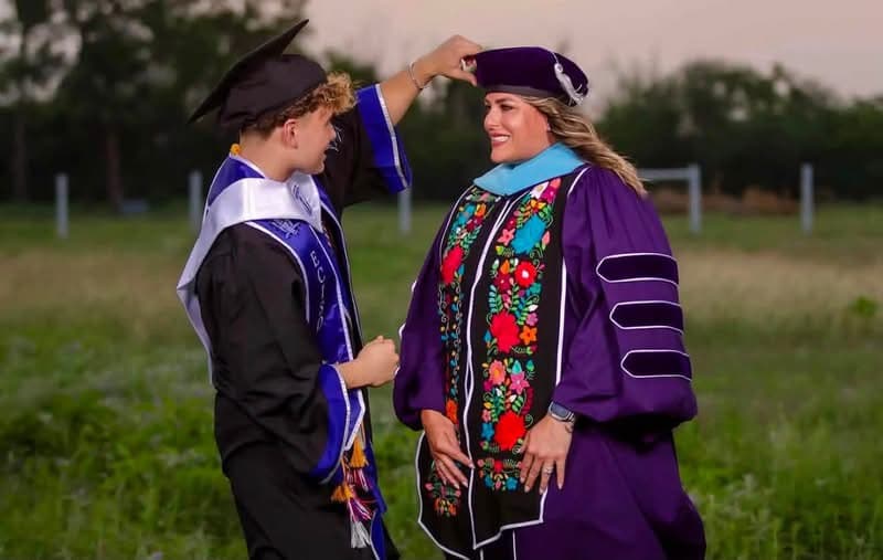 Dr. Karla in her doctoral regalia, celebrating with family
